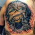 Illustrative style colored chest tattoo of creepy zombie with chain