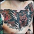 Illustrative style colored chest tattoo of Cerberus head with chain