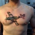 Illustrative style colored chest tattoo of little plane