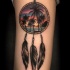 Illustrative style colored dream catcher tattoo on arm