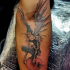 Illustrative style colored forearm tattoo of creepy demon with apple