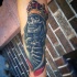 Illustrative style colored forearm tattoo of skeleton king