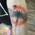 Illustrative style colored forearm tattoo of dragonfly
