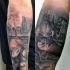 Illustrative style colored forearm tattoo of Batman with night city sights