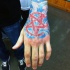 Illustrative style colored hand tattoo of red demonic star