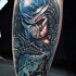 Illustrative style colored leg tattoo of Alien with soldiers