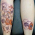 Illustrative style colored leg tattoo of various flowers