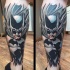Illustrative style colored leg tattoo of Batman