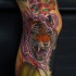 Illustrative style colored leg tattoo of roaring tiger with lightning