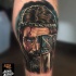 Illustrative style colored leg tattoo of medieval warrior with axe