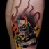 Illustrative style colored leg tattoo of human skull with flames