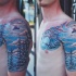 Illustrative style colored shoulder and chest tattoo of snowboarder with forest