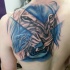 Illustrative style colored shoulder tattoo of lion face with blue lines