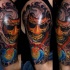 Illustrative style colored shoulder tattoo of demonic mask with fog