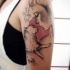 Illustrative style colored shoulder tattoo of woman with cat and lettering