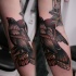 Illustrative style colored sleeve tattoo of big bird