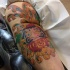 Illustrative style colored tattoo of daruma doll with chrysanthemum