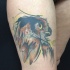 Illustrative style colored thigh tattoo of owl