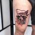 Illustrative style colored thigh tattoo of raccoon sailor