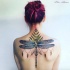 Illustrative style colored upper back tattoo of big dragonfly