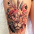 Illustrative style thigh tattoo of big lion head