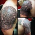 Impressive black and white Celtic style armor like tattoo on shoudler