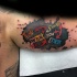 Impressive colored biceps tattoo of funny lettering