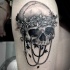 Incredible detailed black ink human skull with flowers tattoo on thigh combined with jewelry