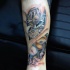 Interesting colored under skin mechanism tattoo on forearm
