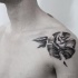 Interesting looking sketch style shoulder tattoo of big rose