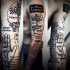 Tatuaje en el brazo, tema científico con mano, árbol e inscripciones