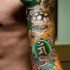 Tatuaggio grande su tutto il braccio i disegni in stile giapponese