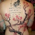 Japanese traditional colored whole back tattoo of blooming tree, lettering and symbol