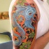 Koi fish with flowers tattoo on half sleeve