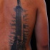 Large amazing looking back tattoo of enormous stone statue