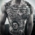 Large black ink chest and belly tattoo of lettering and God father