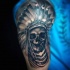 Large black ink shoulder tattoo of Indian skeleton