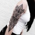 Large black ink sleeve tattoo of Hinduism ornament