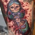 Large bloody looking thigh tattoo of Matryoshka doll with skeleton