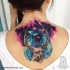 Large colored illustrative style upper back tattoo of deer with space and planet