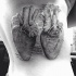 Large engraving style black ink side tattoo of human hearts and lettering