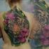Large illustrative style whole back tattoo of tiger with flower and butterfly