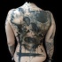 Large incredible looking human skull with woman face tattoo on whole back