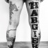 Large modern traditional style black ink lettering tattoo on leg