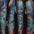 Large multicolored sleeve tattoo of underwater like with sharks and fishes