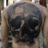 Large realism style black and white back tattoo of human skull