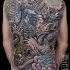 Large very beautiful whole back tattoo of big bird with snake and flower