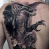 Large very detailed whole back tattoo of fantasy dragon