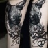 Lifelike black in shoulder tattoo of Sphinx cat with flower