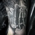 Lifelike black ink tattoo of human skeleton hands